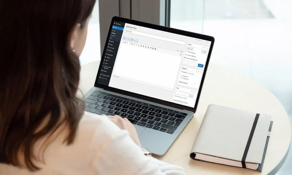 picture of a woman working on a macbook on her wordpress site, learning how to create an online course with wordpress